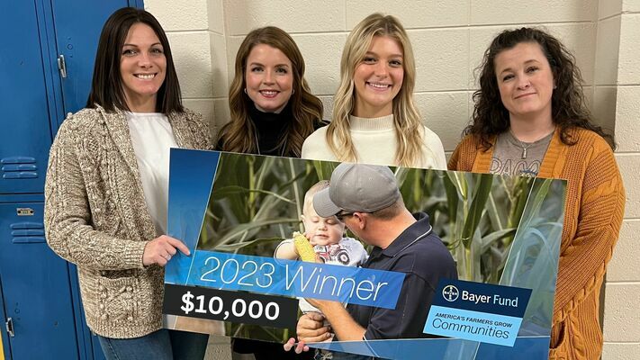 Presenting the Bayer Fund America’s Farmers Grow Communities award is Tory Rodgers (3rd from left), daughter of Shan & Sabrina Rodgers and a senior at DeWitt High School. Science department educators receiving the award are Toni McFerrin, Beth Hill, and Shanna Place. 