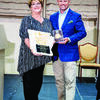 Melody Stackhouse accepts Pat Peacock’s Arkansas Waterfowler Hall of Fame award.