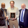 Dr. Chris Morgan (center), was recognized for 10 years of service on the Stuttgart Public School Board of Education. Pictured with (l to r) School Board President, Napoleon Davis Jr. and School Board Superintendent Dr. Rick Gales.