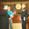 Patrolman Brad Bazarrow gets sworn in as Patrol Sergeant by Judge Eldridge and Chief Tucker.