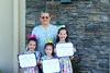 Emma, Violet and Chloe Vanderheiden are shown with their awards with Dyan Bohnert, Children and Youth Chairperson for American Legion Auxiliary Daniel Harder Unit 48 in Stuttgart.
