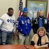 Stuttgart Mayor Norma Strabala signs a proclamation recognizing Phi Beta Sigma while members of the fraternity look on. (l to r) Sylvester Barrow, Larry Thompkins, Tim Johnson, Johnny Warren II, and Charles Dabner.